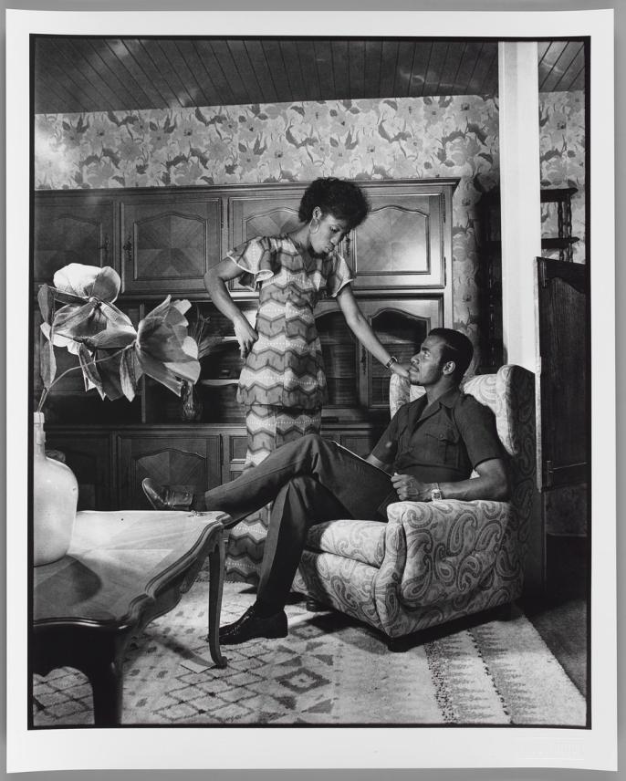 A photograph of a couple in a living room by Paul Kodjo