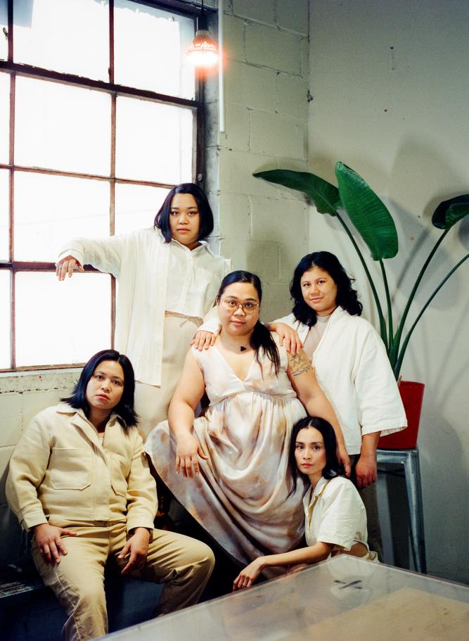 An image of the group Pantayo posing in front of a window and large green plant.