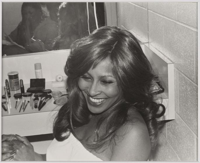 A photograph of the singer Tina Turner backstage after a show in Hamilton, Ontario. It is a candid photo of Tina smiling at her interviewer