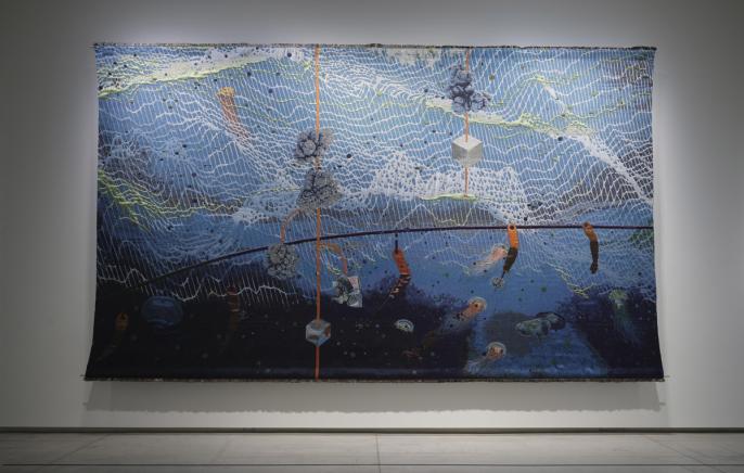 An installation image of Otobong Nkanga's unearthed - midnight, an 11x18 foot tapestry