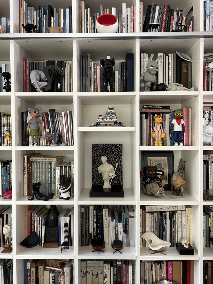 Bookshelf with art toy collection in John Wee Tom's home