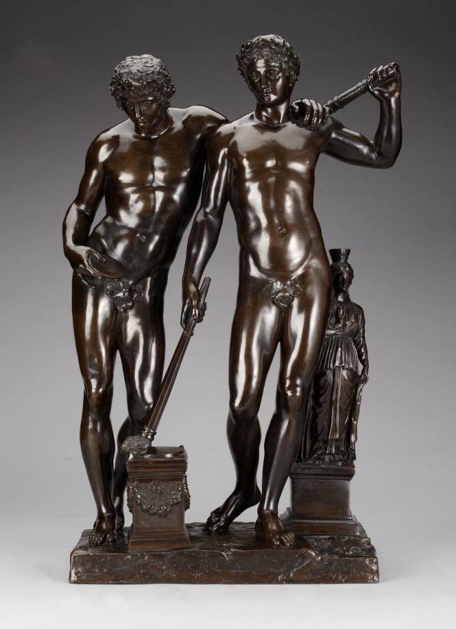 Bronze statue of two male nude figures holding torches