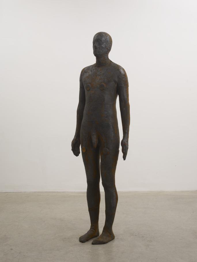 free standing cast iron sculpture of an anonymous human man