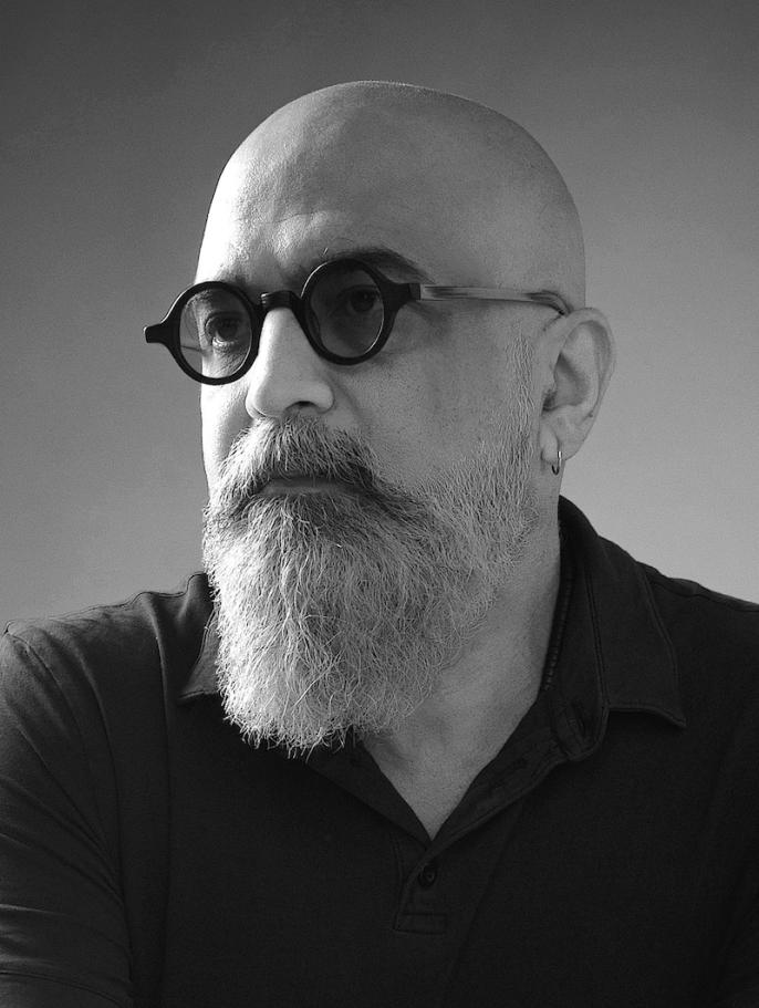 A black-and-white headshot of hybrid artist Faisal Anwar