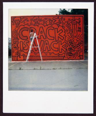 An outdoor mural saying Crack Is Wack by Keith Haring