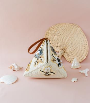 a triangle bag made out of weaved textiles from the Philippines