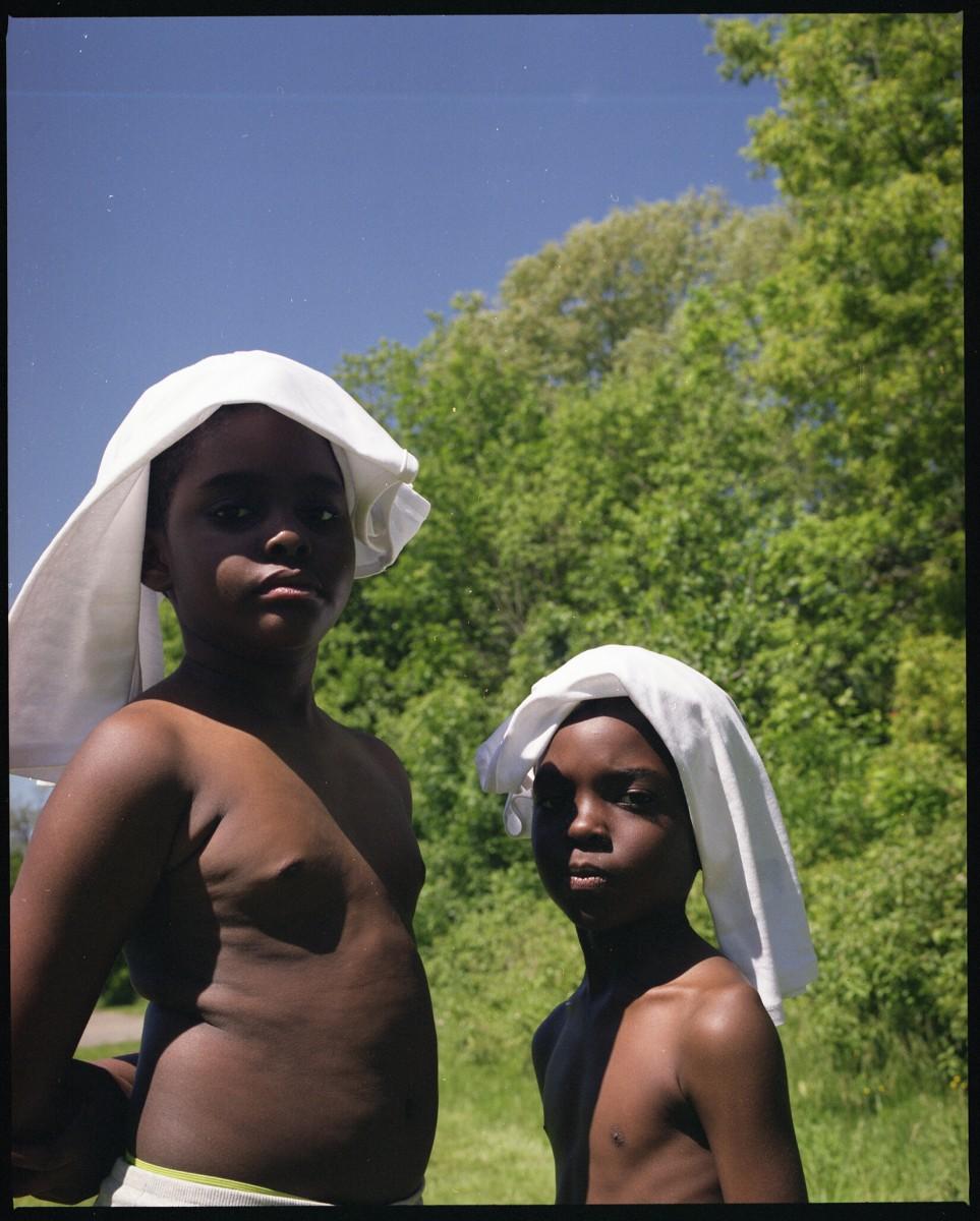 A photo of two young boys standing in a field.