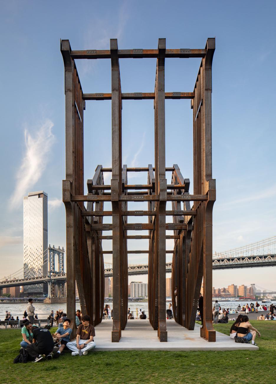 LAND Sculpture by Nicholas Galanin  (side view) with people sitting