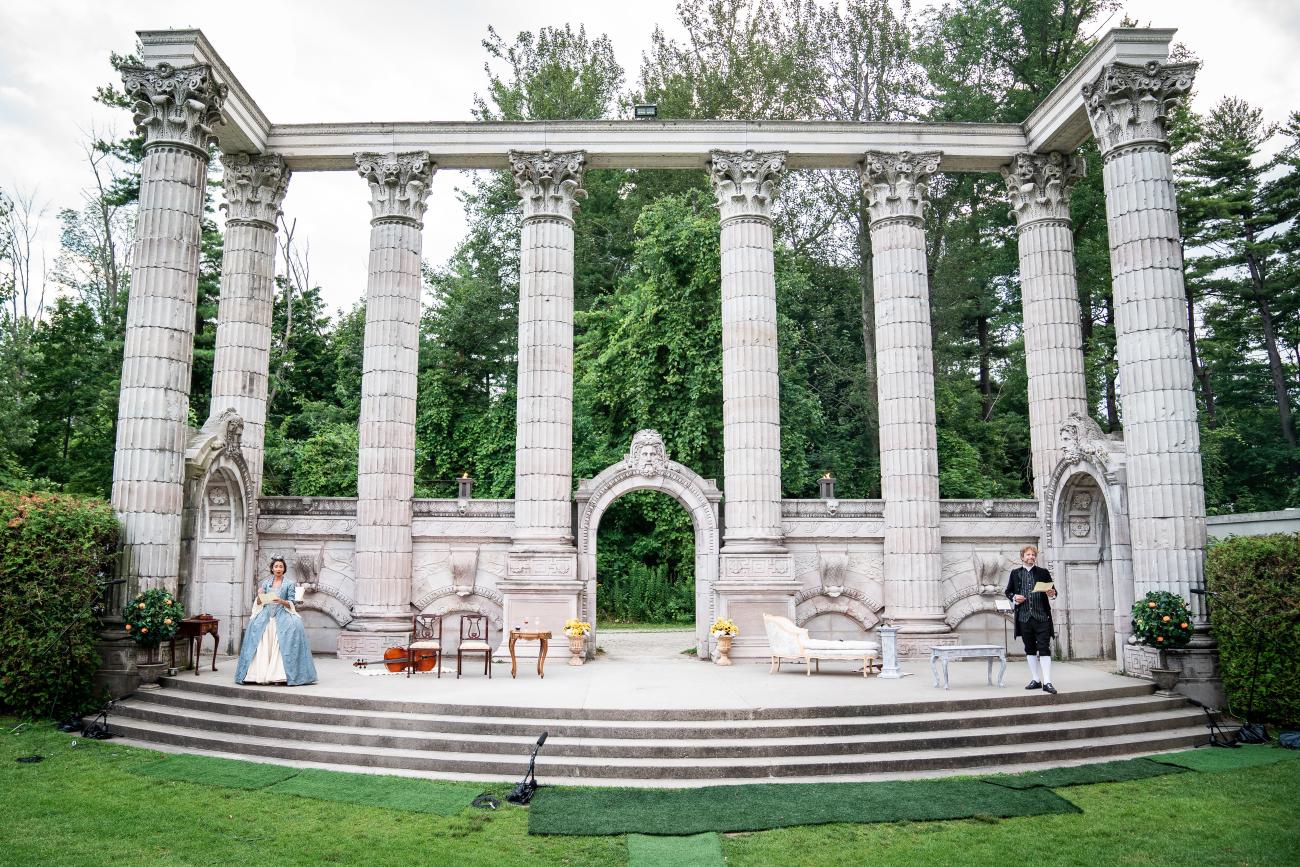 An image of Guild Festival Theatre's production of The Red Priest, featuring two actors in Victorian-era clothing standing on opposite sides of the theatre