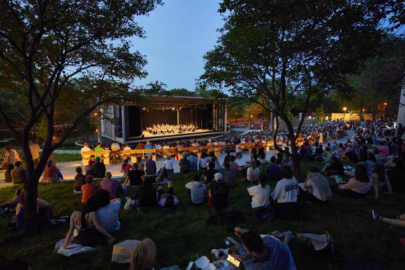 An image of people at Théâtre de Verdure in Montreal watching Orchestre Métropolitain perform in 2022