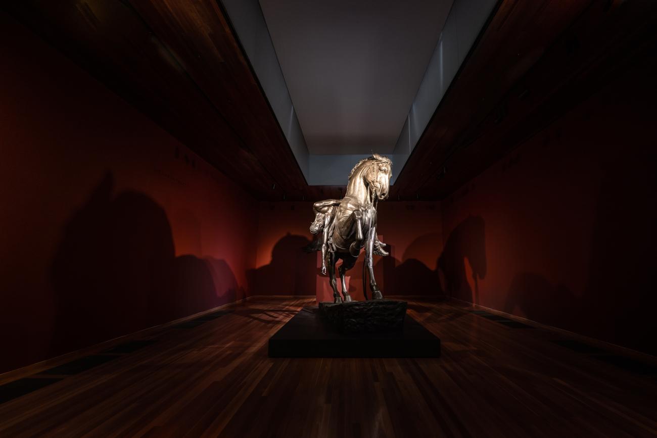 An image of Kehinde Wiley's sculpture An Archaeology of Silence, which features a young black man laying across a horse