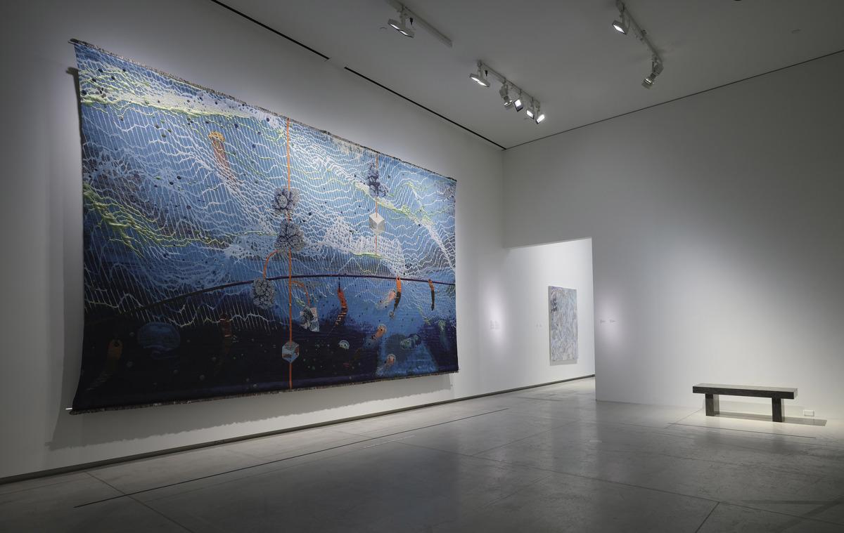 An installation image of Otobong Nkanga's unearthed - midnight, an 11x18 foot tapestry