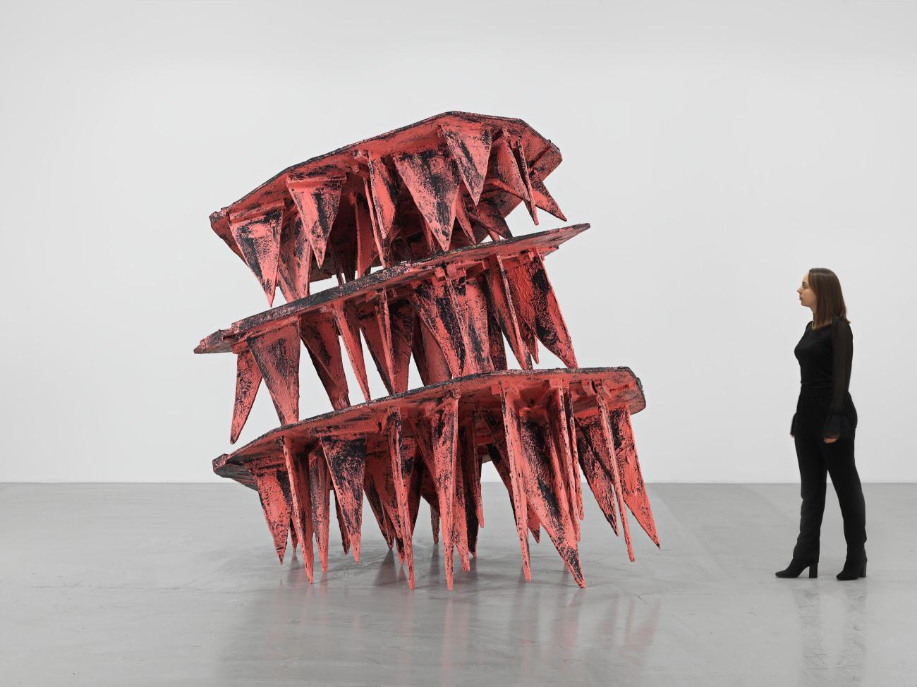 A sculpture of three layers of pink spikes