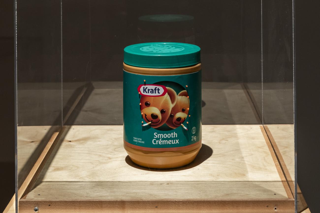 An image of a Kraft smooth peanut butter jar, but the bears have beaded cigarettes in their mouths