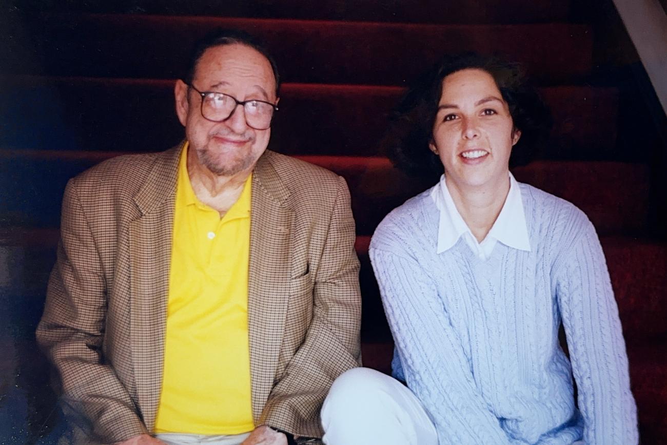 Colour photo of photographers Arnold Newman (L) and Elizabeth Greenberg (R) seated on stairs.