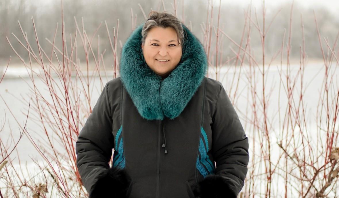 a woman wearing a mint green suit and a green coat Stock Photo by Icons8