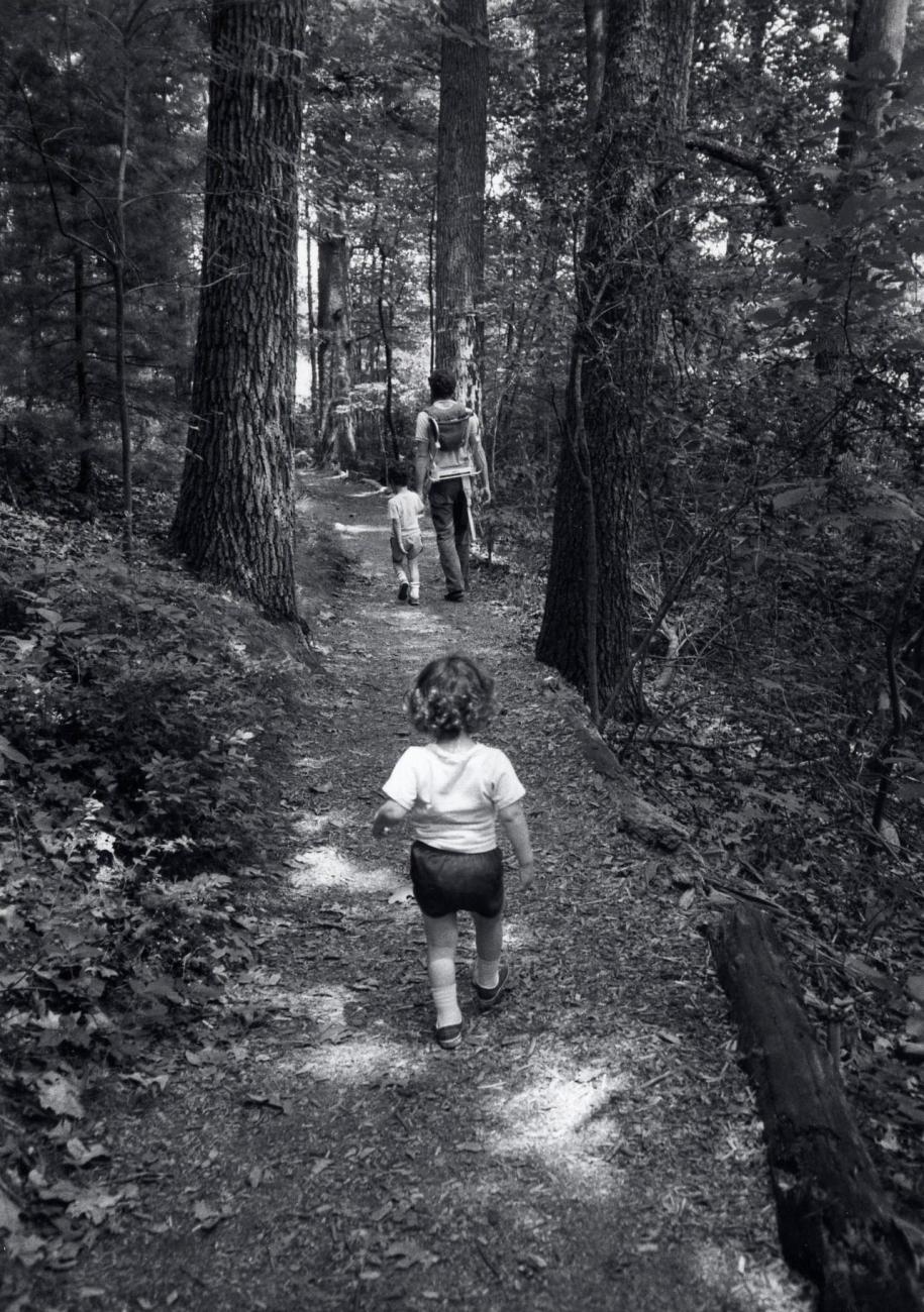 Father with two children in the woods