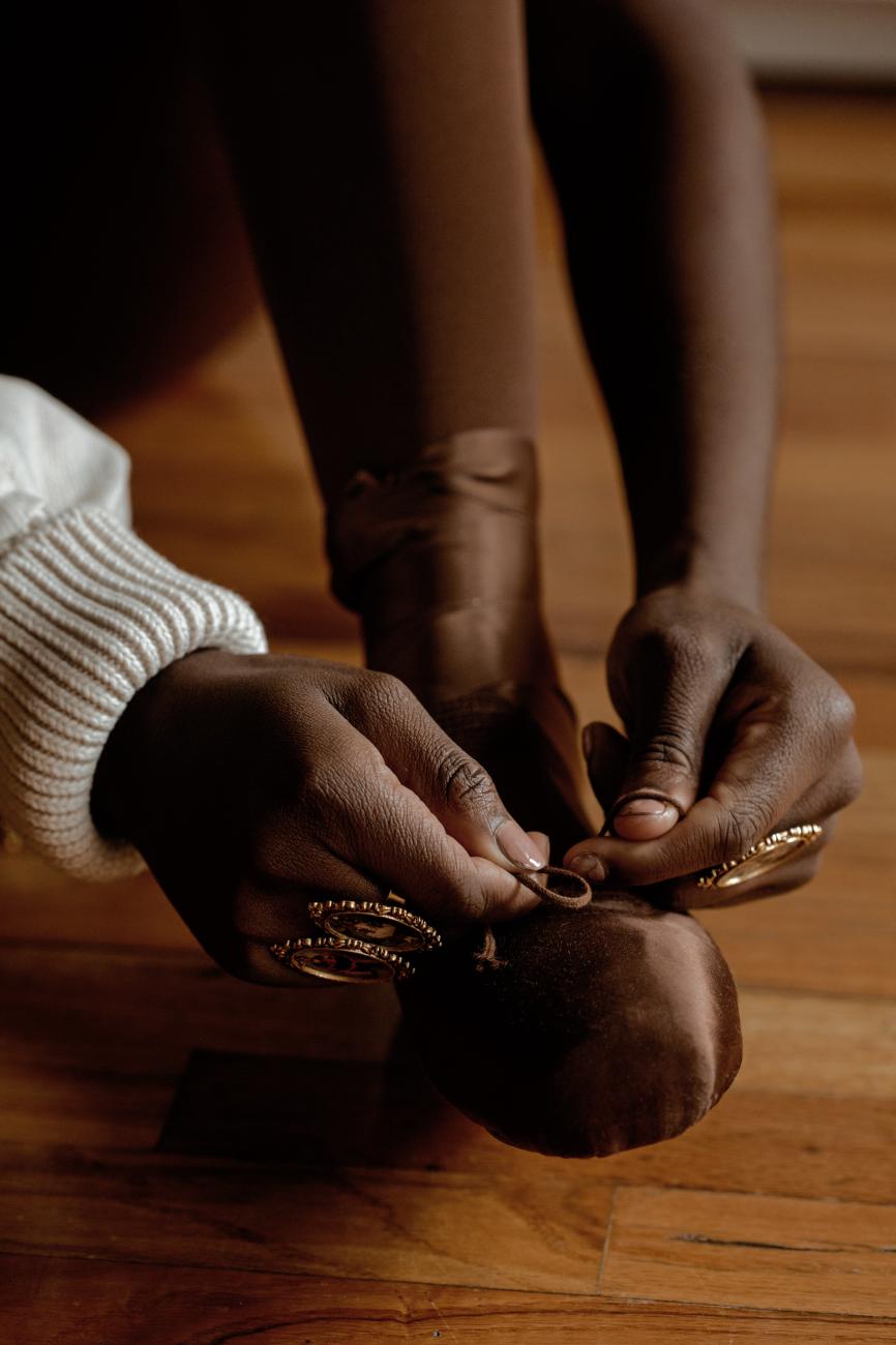 A close up photo of Jordan Peterson tying her pointe shoes