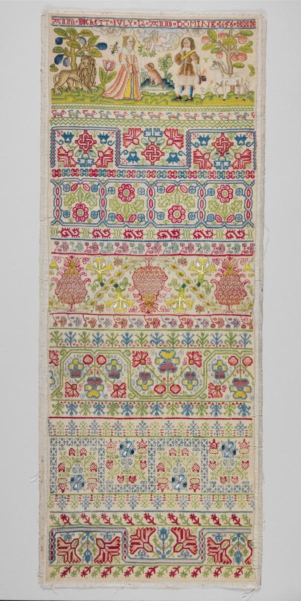 A embroidered piece of linen featuring horizontal bands