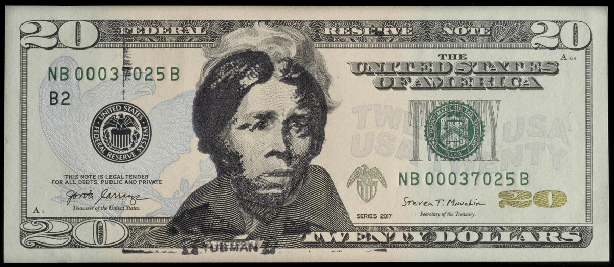 U.S. 20 dollar bill overstamped in black ink with an image of Harriet Tubman