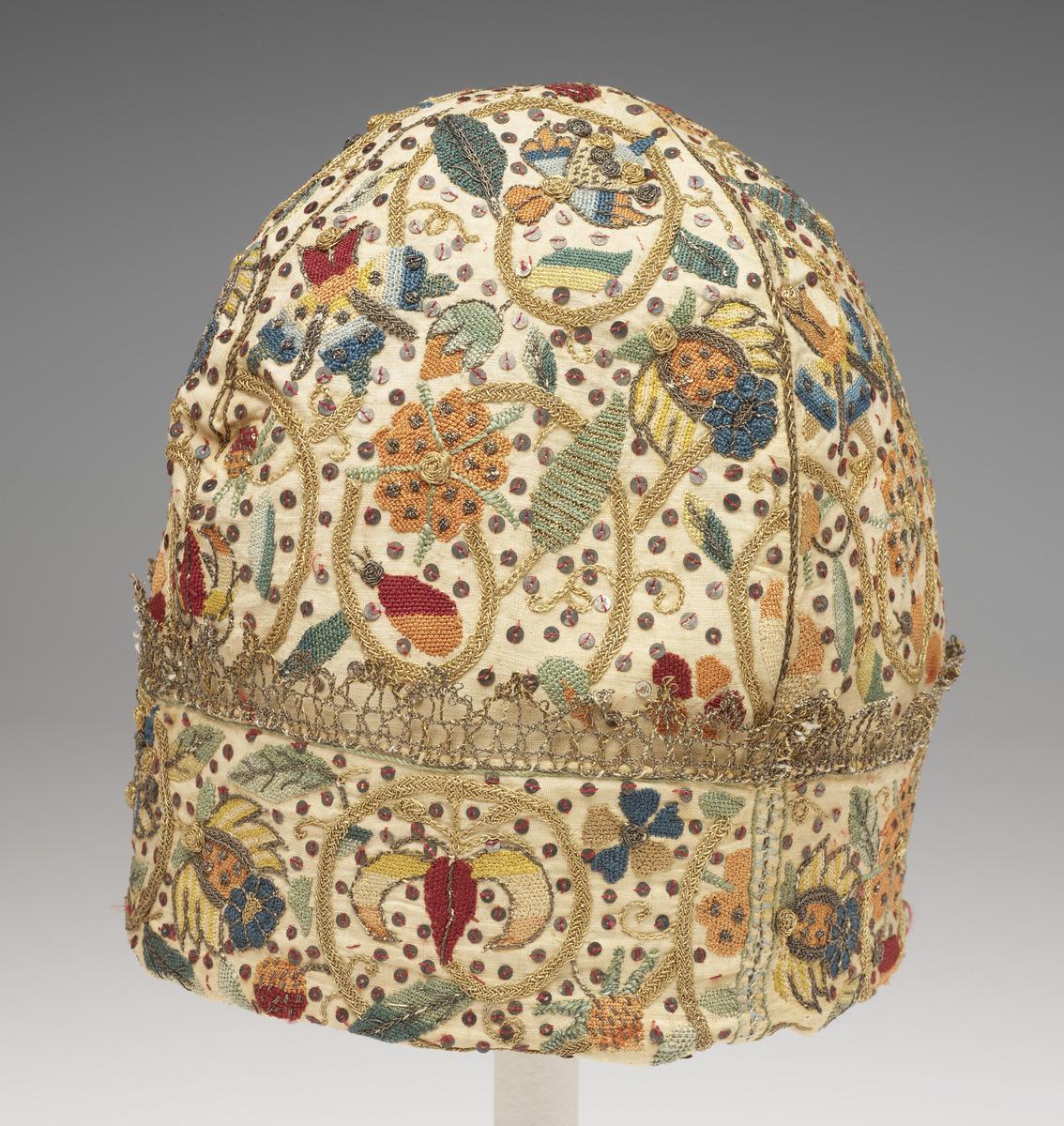 a man's night cap embroidered with sequins and metallic thread
