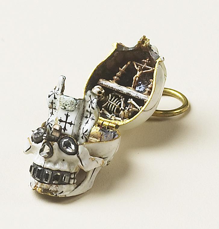 pendant of a skull with head opened revealing skeleton inside