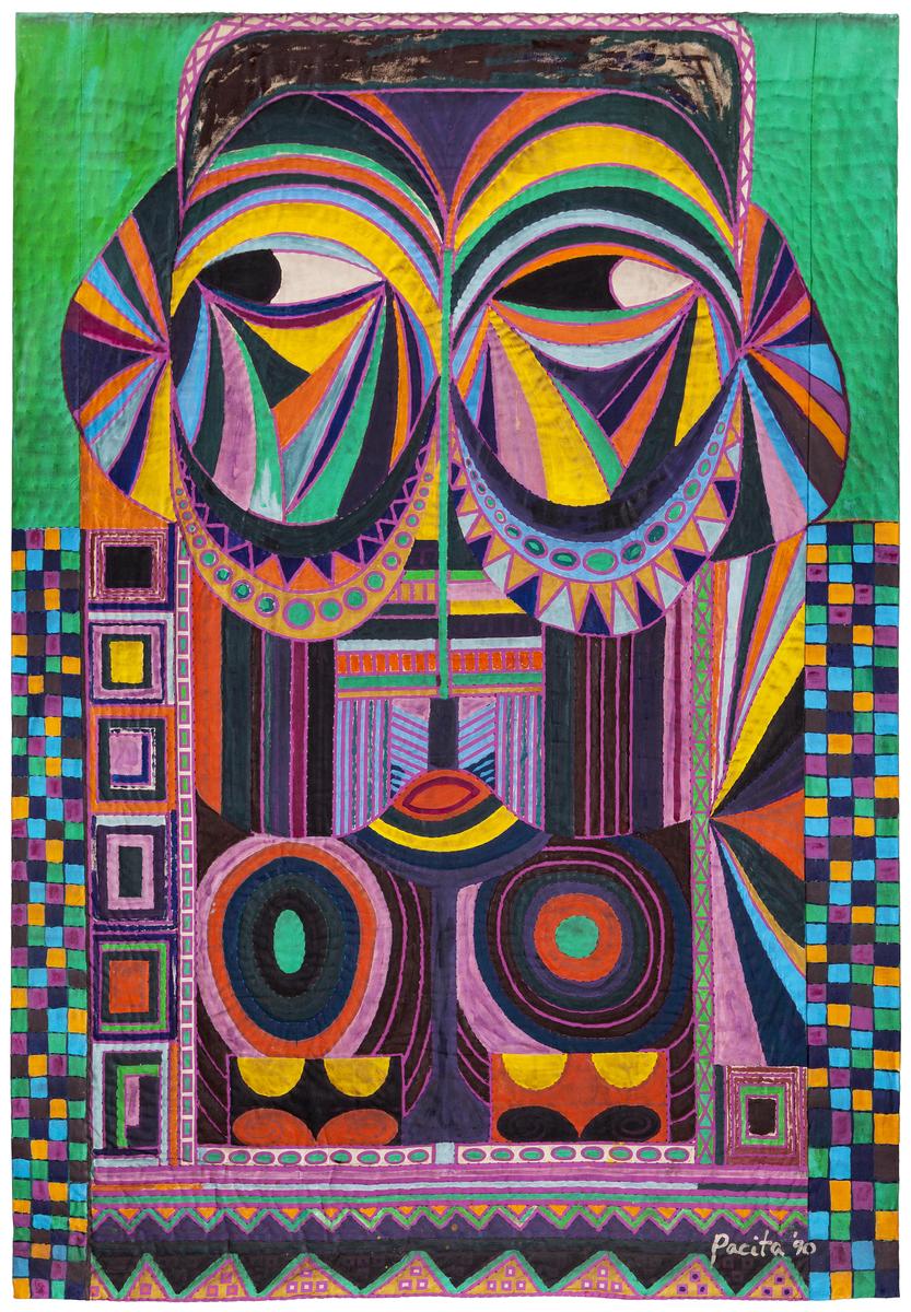 An image of Pacita Abad's trapunto European Mask. It features a multicolour mask inspired by bifwebe masks from the Republic of Congo and the Democratic Republic of Congo. The eyes of the mask peer to the left.