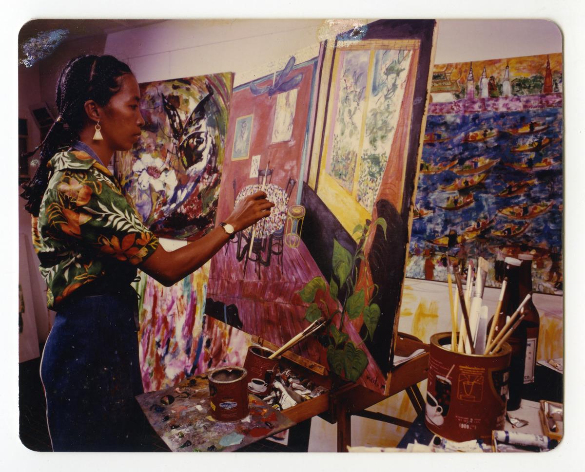 An image of artist Pacita Abad painting in her studio in Bangkok