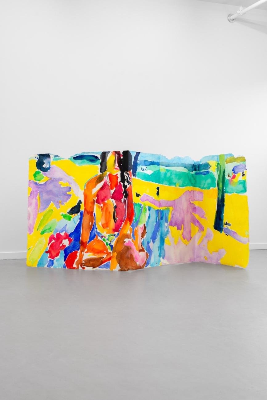 An image of Maru Aponte's work Veronica, which features a woman on a beach wearing a biking on a folded canvas standing on the ground.