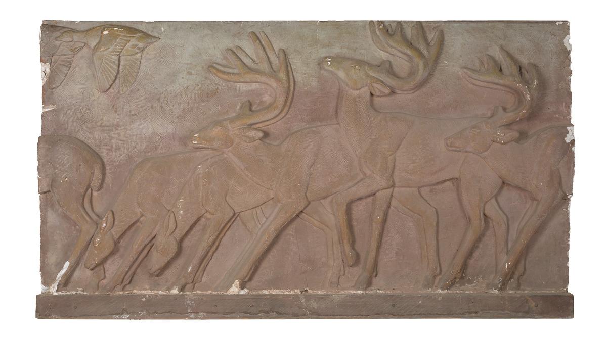 A model of a relief sculpture featuring deer running across a field