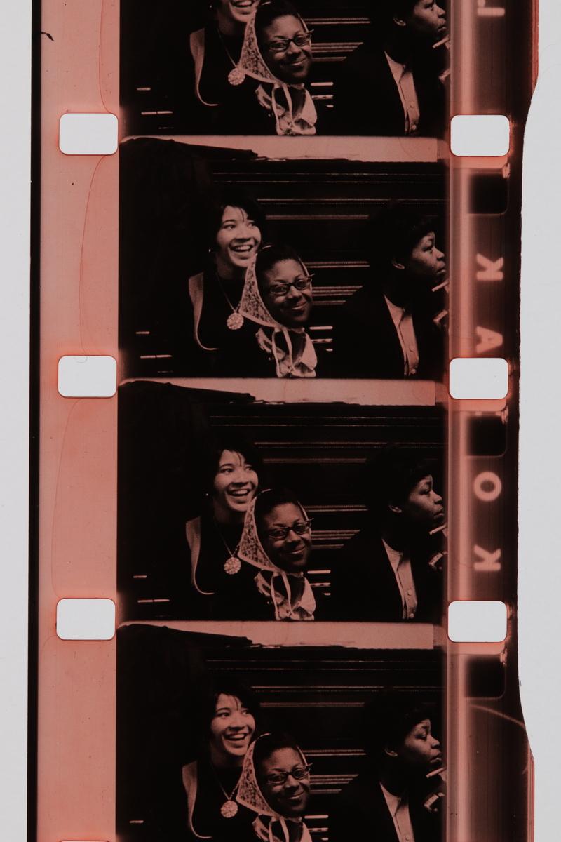 film strip showing women smiling from Joyce Wieland's work titled Handtinting