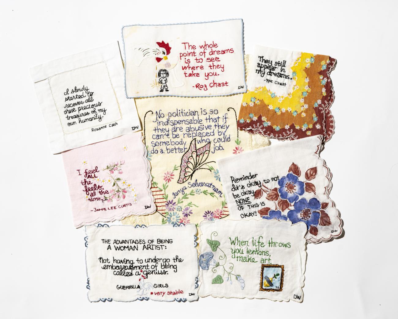 A collage of textiles with different quotes stitched onto them, created by multiple contributors to the Tiny Pricks Project