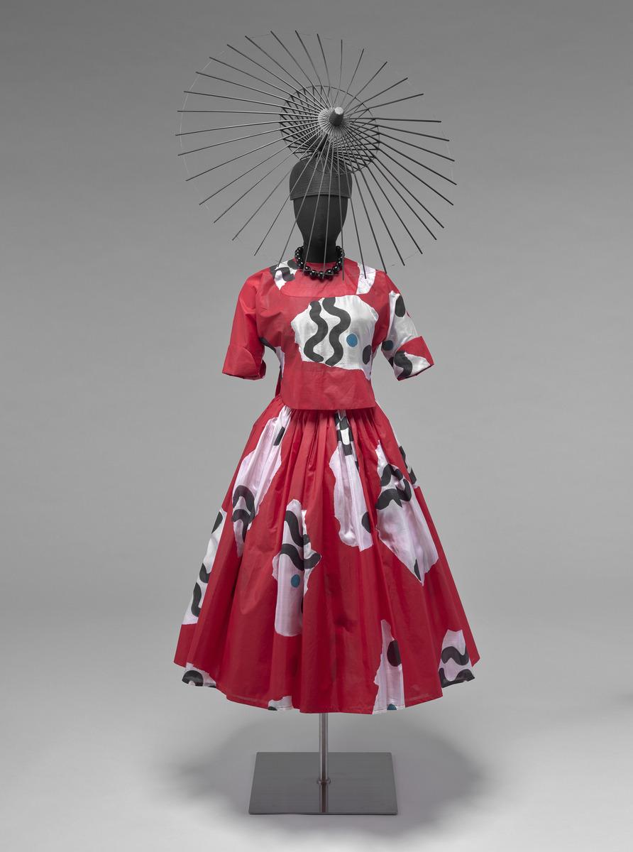 Geoffrey Holder. Red fitted top and flared skirt
