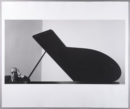 The famous Stravinsky portrait. Stravinsky sits at a piano. 