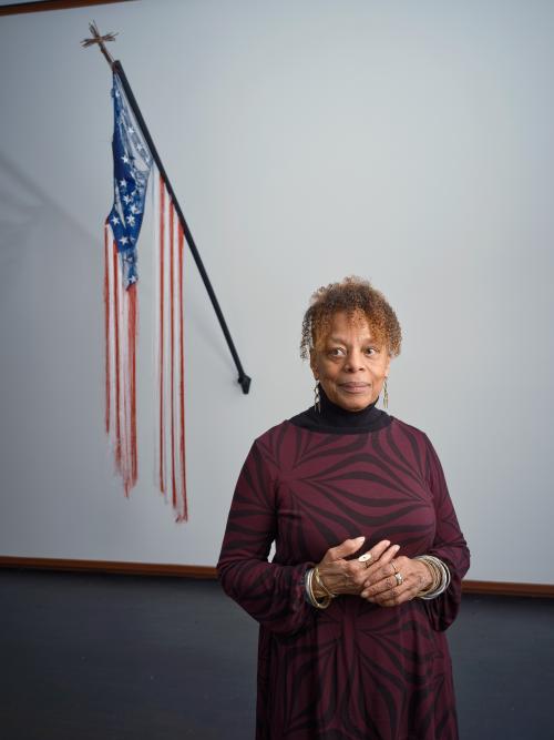 A photo of artist June Clark with one of her installation works 