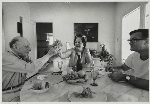 Black and white photograph of three people seated at lunch