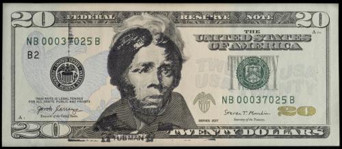 U.S. 20 dollar bill overstamped in black ink with an image of Harriet Tubman